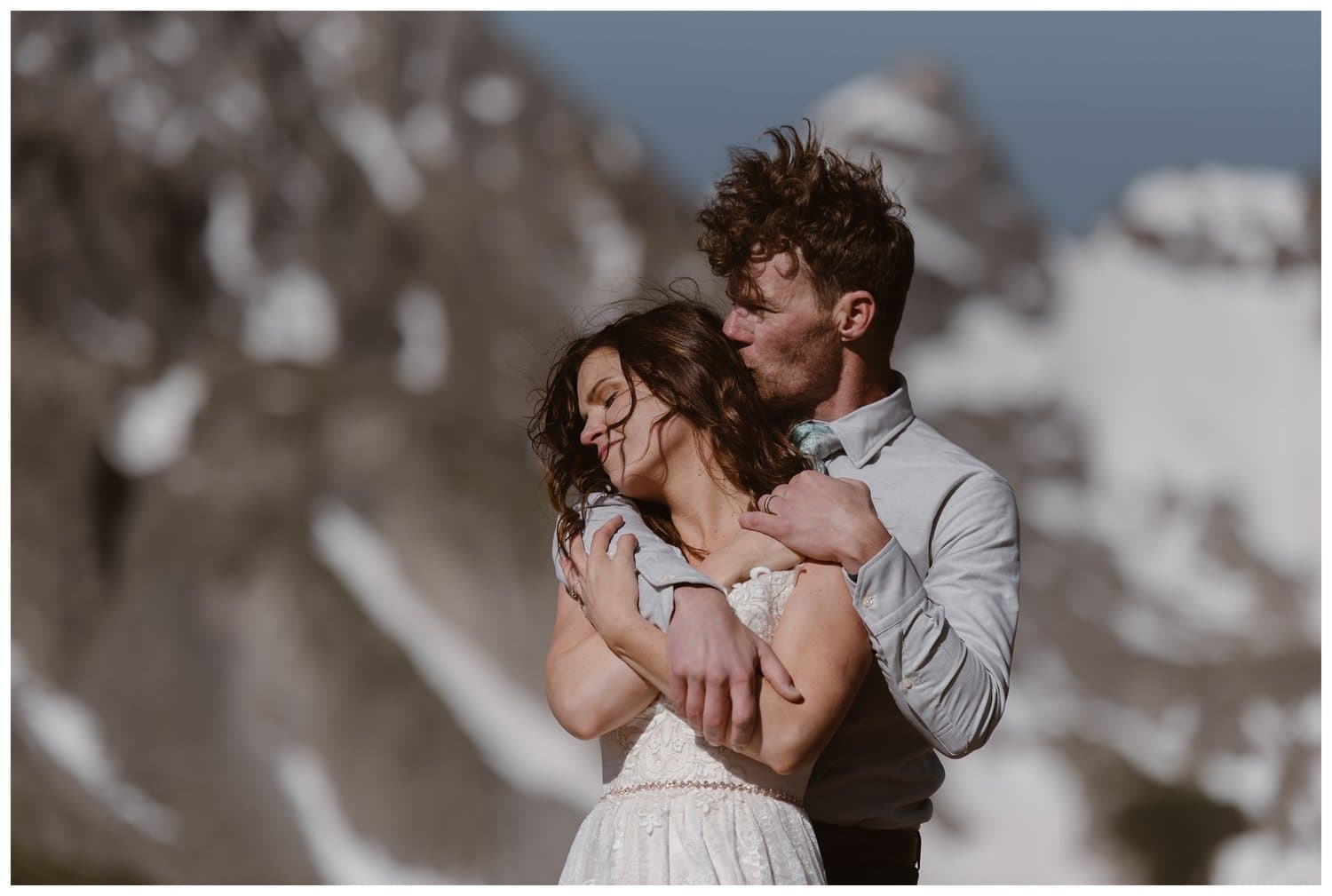Bride and groom embrace at the Indian Peaks in Colorado, on their elopement day. 