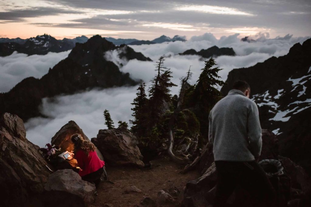 Bride and groom getting ready on Mt. Ellinor at Olympic National Park during sunrise. 