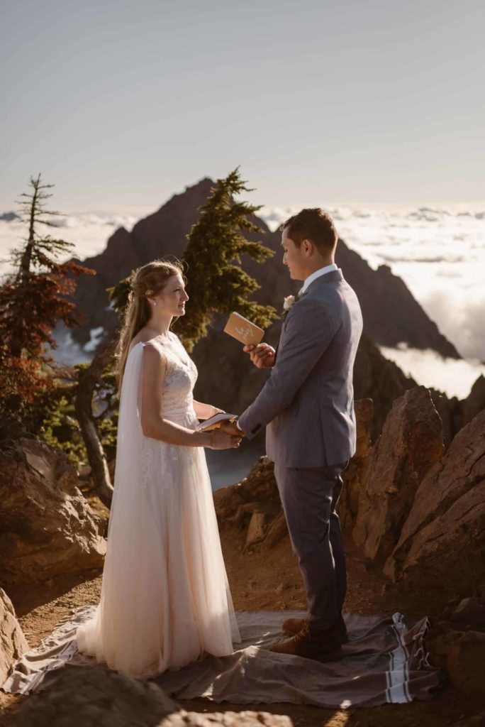Bride and groom read their vows on Mt. Ellinor at Olympic National Park. 