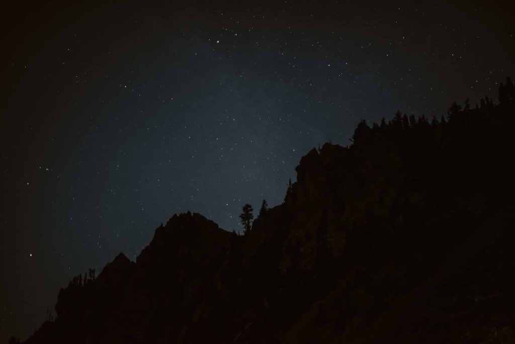 Outline of mountains in the dark, with stars in the sky at Olympic National Park. 