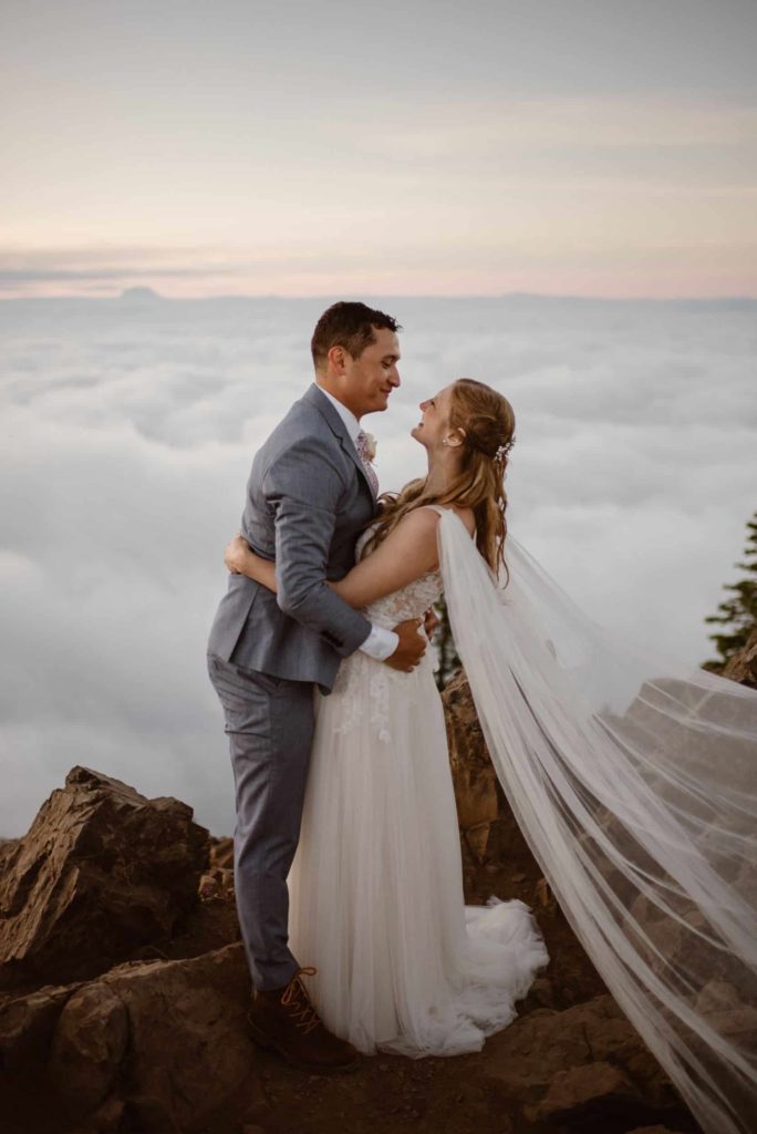 Bride and groom embrace on top of Mt. Ellinor at Olympic National Park. 