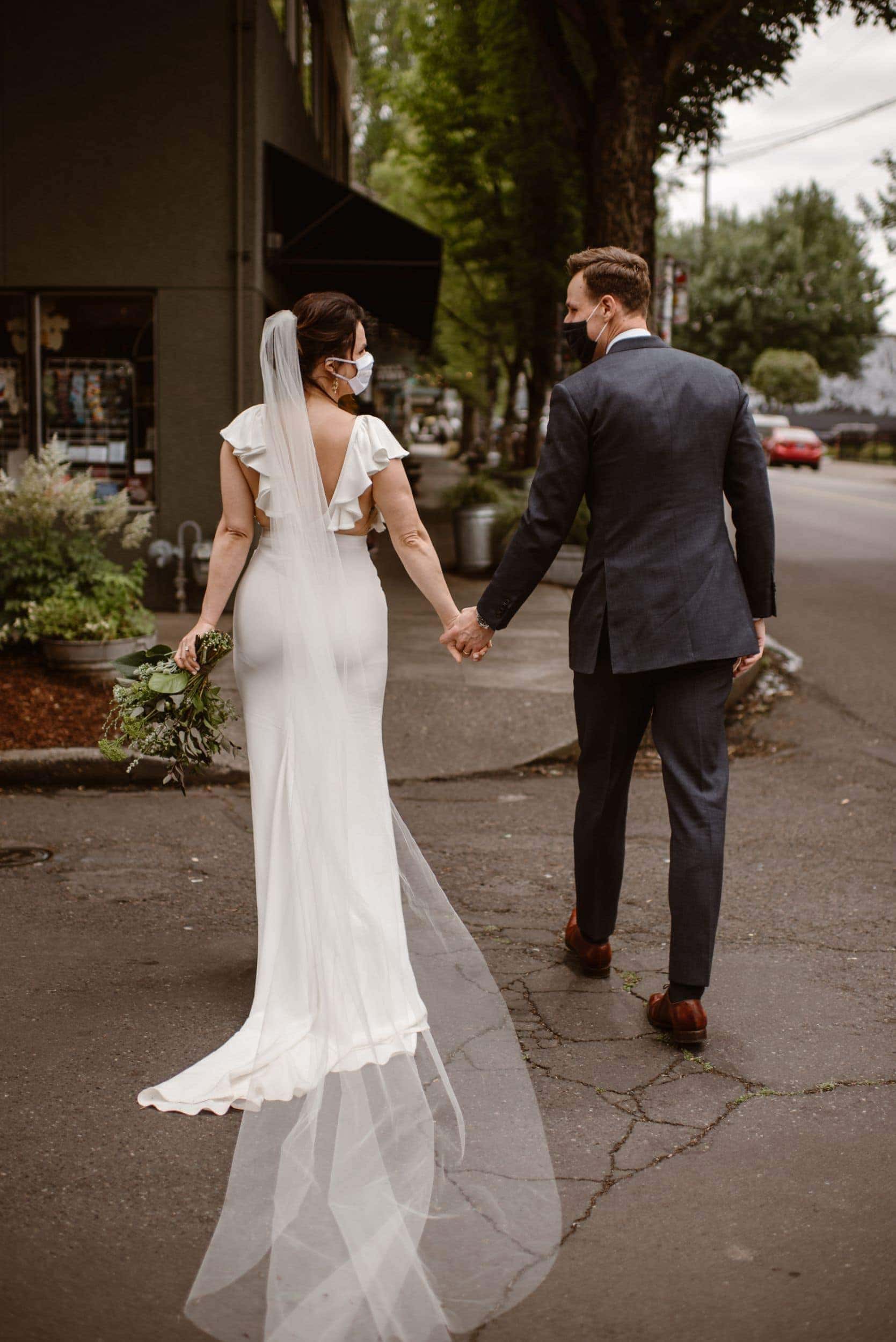 Bride and groom walking around Portland, Oregon with masks on. 