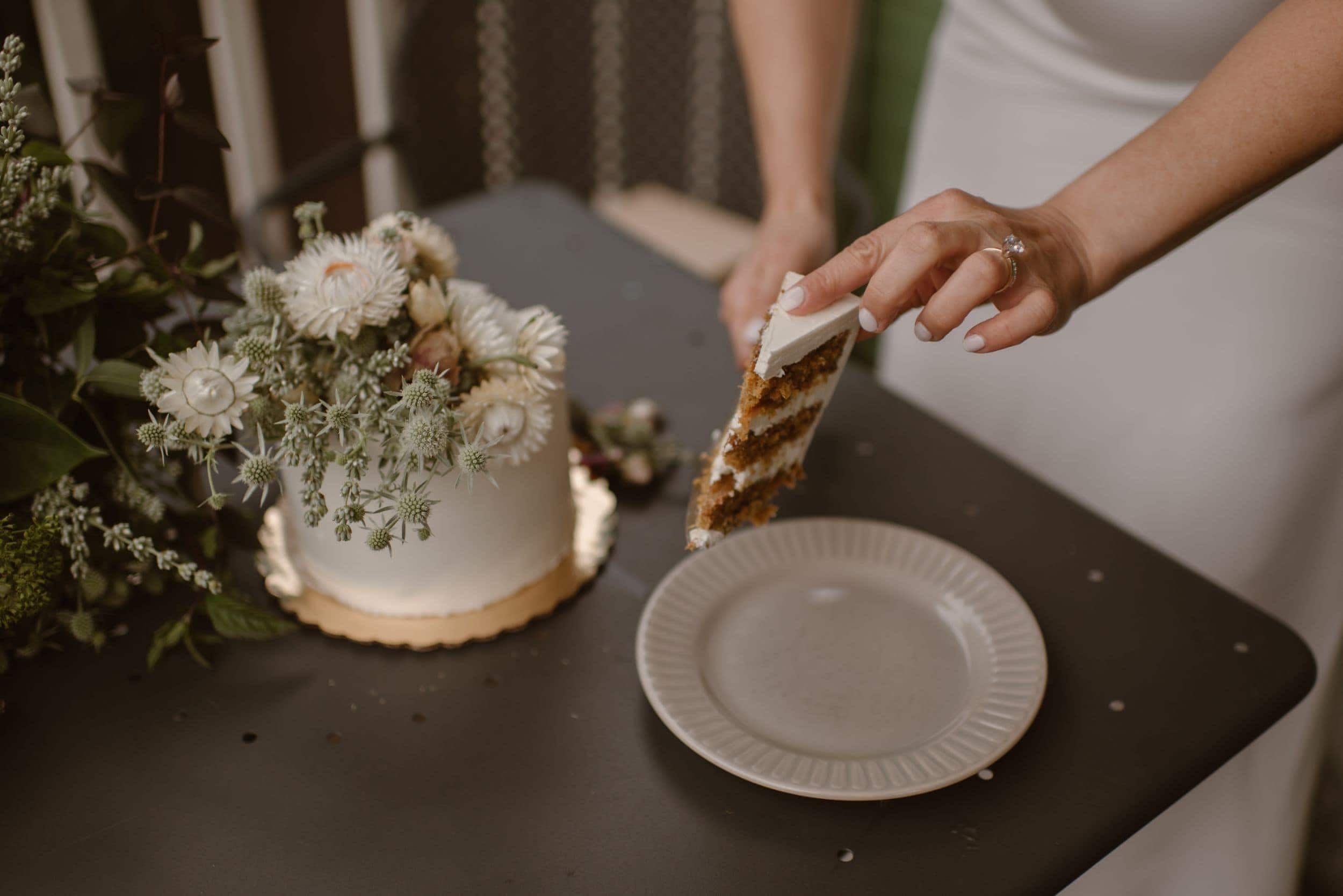 Bride putting a piece of carrot cake on a plate. 